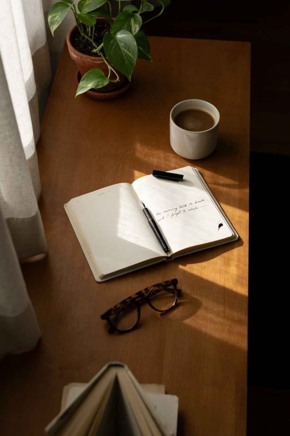 27 A close-up variation of the morning desk prayer corner idea, good for zooming in on the journal itself - 20 Cozy Prayer Corner Ideas for Small Bedrooms (Even a Studio Apartment) A close-up variation of the morning desk prayer corner idea, good for zooming in on the journal itself.